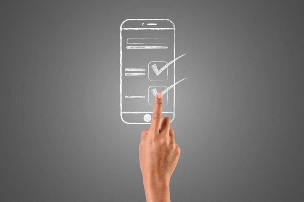 スマートフォンをタッチする指